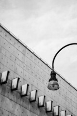 Fototapeta na wymiar black and white architecture: street lamp and a wall
