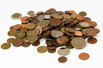 Metal pile of coins isolated on white background, different change spilled on platform,  Messy money, saving coin