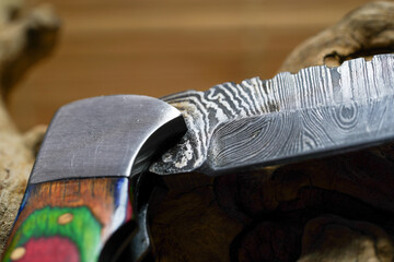 Damask hand-forged knife made of several layers of steel with an exclusive pattern photographed in the studio