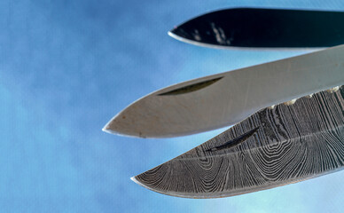 Damask hand-forged knife made of several layers of steel with an exclusive pattern photographed in the studio