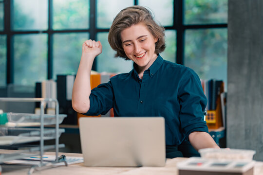 Excited woman sit at desk feel happy win online lottery, Woman overjoyed get mail at computer being promoted at work, female amazed read good news at laptop.