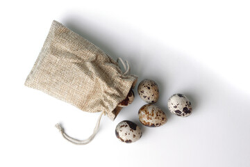 White Easter eggs in a string bag on a white background. Geometry. Minimal concept. Top view. A card with a copy of the place for the text