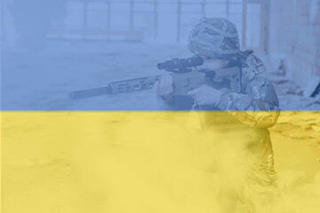 No war. The military soldier in uniform keeps a modern rifle in his hands, on Ukraine flag background