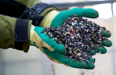 Close up of granulated plastic waste on a recycling plant for plastics. Plastic recycling...