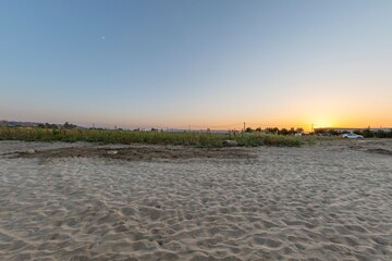 Mediterranean landscape with beach at sunset