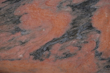 Natural stone background. Dark gray and coral colors.