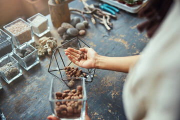 Professional florist making a glass geometric florarium