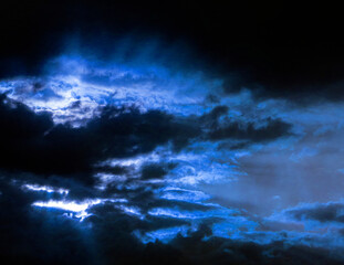 Naklejka na ściany i meble Blue dark cloudy landscape. Heaven background. Sunlight.