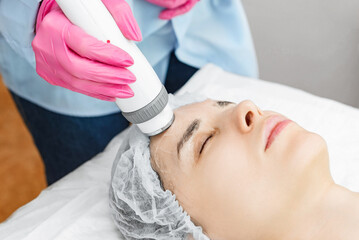 Fototapeta na wymiar Radio wave face lifting in a cosmetology clinic photo. Skin treatment. Hardware cosmetology.