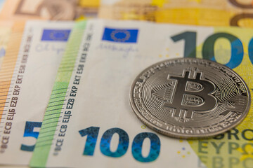 bitcoin on euro banknotes close-up