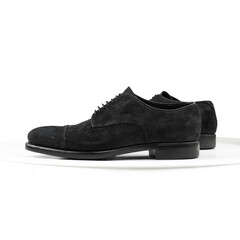 Black suede derby on a white background