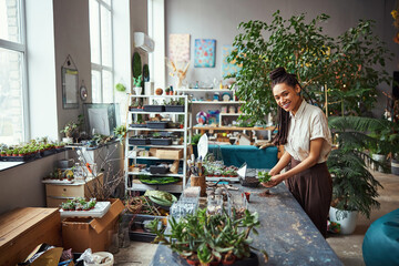 Fototapeta premium Lovely floral designer posing for the camera in the workplace