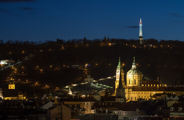 evening view of the Church of St. Nicholas and the Petrin Lookout Tower