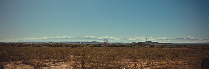 Steppe landscape, in the background layered mountains.