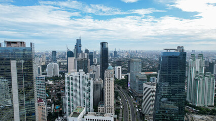 Aerial view of quiet traffic on Sudirman street with skyscrapers during weekend in Jakarta city....