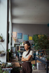 Happy floral decorator looking into the distance