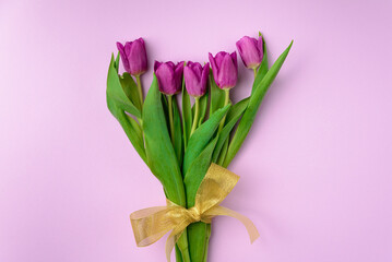 Bouquet of purple tulips on a purple background. The concept of gift flowers for the holidays Women's Day, March 8, Mother's Day.