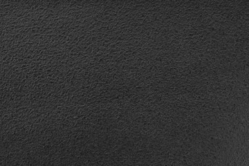 Black textured vinyl background. Full frame