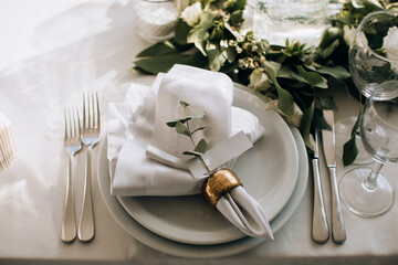 Elegant white dining table setting in the restaurant for the wedding dinner - obrazy, fototapety, plakaty