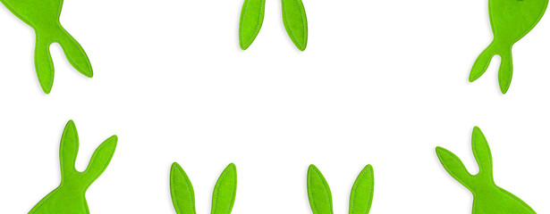 Stitched green rabbits peeking out on white isolated background. Banner, holiday, symbol of Easter,...