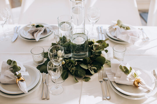 Beautiful white table setting for wedding celebration in restaurant