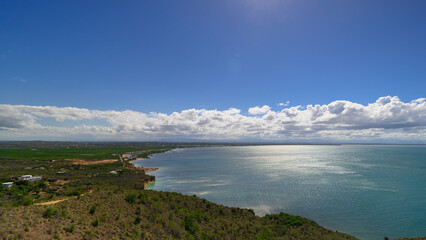 View from the mountain to bay in ocean. Beautiful blue sky with clouds.
