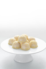 Amazing airy cake on the shelves. White background. Selective focus. Copy space.