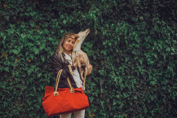 Girl and dog with red suitcase happy for vacation