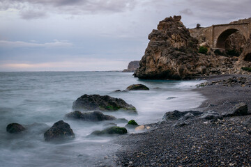 Obraz premium Beautiful nature landscape of Aguadulce Beach, located in Almeria, Spain with unique formation rocks, (Sunrise seascape ,Soft focus due to long exposure shot.)