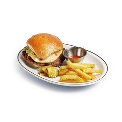 appetizing burger traditional serving on a plate with sauce and fried potatoes