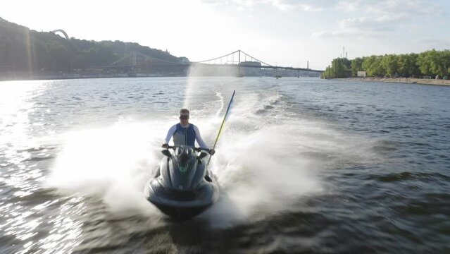 Group of jet skis rushes along the Dnieper with the flags of Ukraine. Summer. Aerial. 