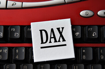 DAX - abbreviation on a white sheet against the background of a computer keyboard
