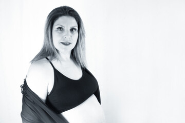 Eight month pregnant woman with bare belly