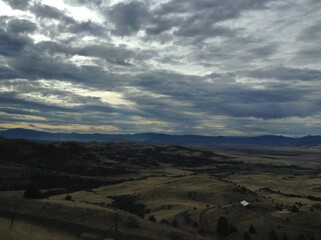 a view of the desert valley on a cloudy day