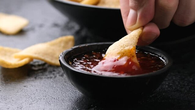 Dipping Prawn Crackers in sweet chilli sauce