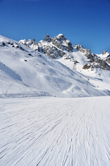Fototapeta na wymiar Ski slope on snowy mountain 