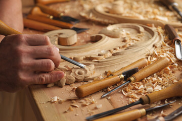 Man working with woodcarving instruments