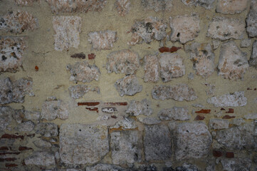 Wall from an old block made of shell rock and red brick background.