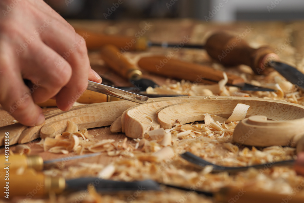 Wall mural wood carving, master's hand work with a wooden surface