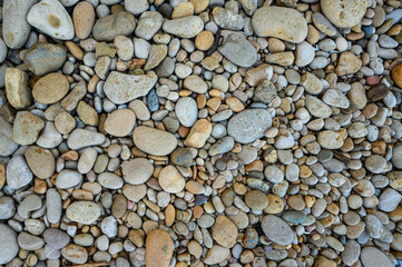Large and small colored pebbles. Abstract background. View from above