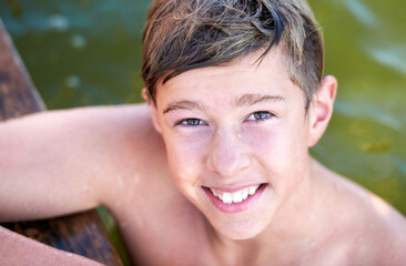 Simple joys. Portrait of a teenage boy having a swim in a lake.