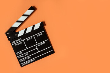 clapperboard shooting video movies orange background copy space - obrazy, fototapety, plakaty
