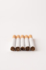 blonde cigarettes with filter on a white table, white background