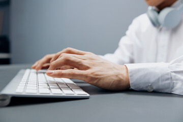 man sitting at a table with a keyboard in the office isolated background
