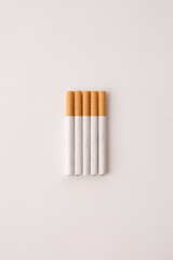 blonde cigarettes with filter on a white table, white background