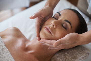 Theres no better way to relax. Shot of an attractive woman enjoying a face massage.