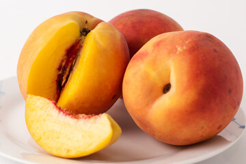 Naklejka na ściany i meble ripe peaches on a plate, white background