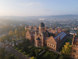 City panorama from the air, shot from a drone. Yury Fedkovych national University in Chernivtsi. City morning landscape with foggy haze. UNESCO monument in Ukraine