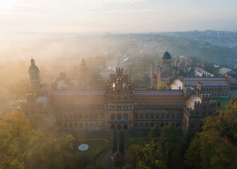 City panorama from the air, shot from a drone. Yury Fedkovych national University in Chernivtsi. City morning landscape with foggy haze. UNESCO monument in Ukraine