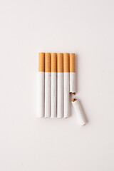 blonde cigarettes with filter on a white table, white background